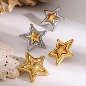 Two-tone gold and silver star stud earrings with a 3D embossed metallic texture