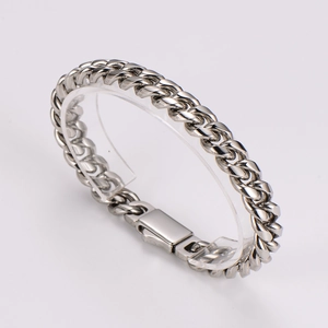 Macro side view of a polished silver stainless steel Cuban link bracelet with a secure clasp