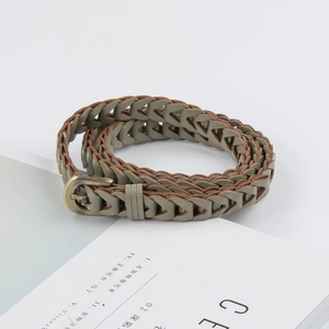 Olive green braided skinny belt for women with vintage bronze metal buckle on white book