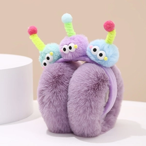 Detail of purple plush earmuffs with cartoon monster eyes and colorful pom-poms.