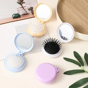 Portable folding hair brush with mirror in pastel beige, white, blue and purple colors