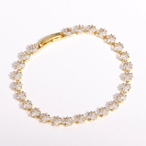 Macro shot of gold-plated bracelet featuring square-cut zircons on a white background