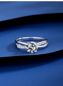 Macro shot of a 1-carat round moissanite ring with four-prong criss-cross silver band