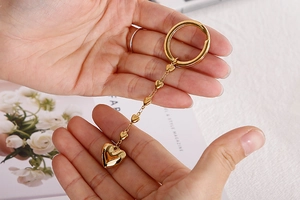 Close-up of golden stainless steel heart keychain with multiple linked heart charms