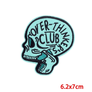 Close-up of turquoise skull embroidery patch with Over-Thinker's Club text and detail