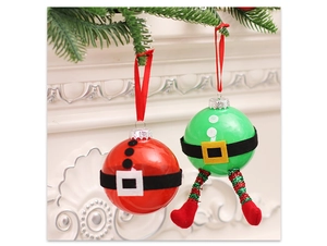 Detail of Christmas balls with Santa and Elf designs hanging on white carved background