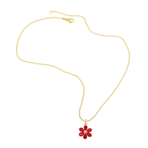 Detail of a golden bead chain necklace featuring a vibrant red floral gemstone pendant