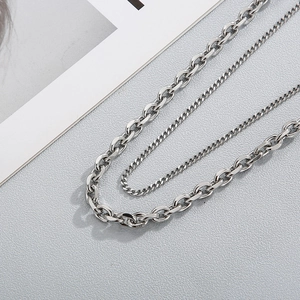 Detail of silver titanium steel double layered necklace with O-chain and Cuban links