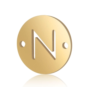 Macro view of a gold stainless steel round pendant with a cutout N letter and dual holes