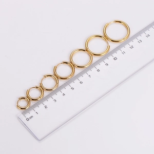 Polished gold round hoop earring set in six different sizes shown with a ruler scale