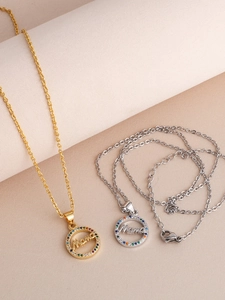Detailed view of Mama circle pendants with rainbow pave zircons in gold and silver finish