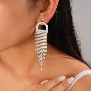 Close-up of sparkling silver jellyfish tassel earrings with zircon fringe on a model