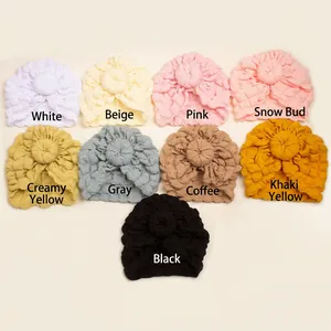 Detail view of baby turban hats in 9 colors with soft textured waffle knit fabric