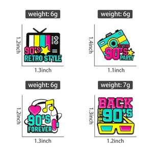 Retro 90s enamel pins showing vintage TV, camera, and headphone details and dimensions
