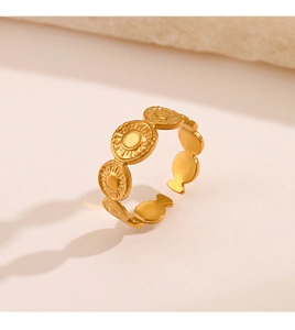 Detail of adjustable gold-plated stainless steel ring with circular celestial sun patterns