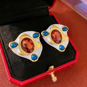 Vintage gold oval geometric earrings with red gemstones and blue accents in a gift box