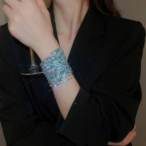 Close-up of sparkling blue rhinestone multi-layer wrap bracelet on model's wrist