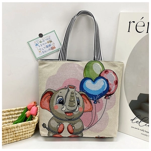 Detail of canvas tote bag featuring cute elephant embroidery and striped ribbon handles