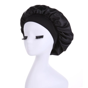 Close-up of black satin sleep cap with wide elastic band on a white model head