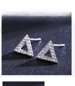 Macro view of triangular S925 sterling silver studs with micro-pave cubic zirconia crystals