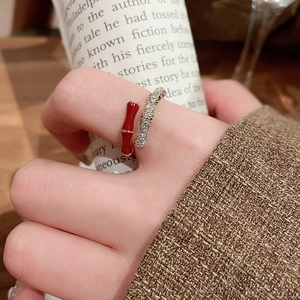 Detailed view of a 14k gold plated bamboo ring with red enamel and pavé zircon stones