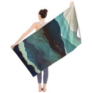 Artistic microfiber beach towel with blue landscape and gold accents for travel