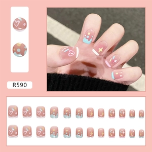 Detail of 24pcs pink press-on nails featuring cute heart patterns and colorful dots