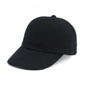 Close-up of the black cotton twill texture and stitching on a classic baseball cap