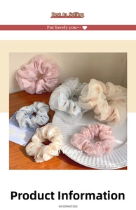 Close-up of mesh scrunchie set with floral daisy prints on a white vintage plate