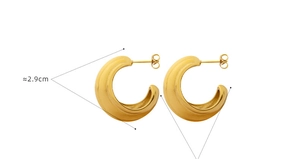 Detail view of 2.9cm gold-plated C-shaped hoop earrings with matte brushed texture