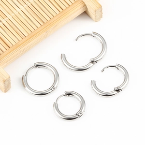 Set of four minimalist silver stainless steel hoop earrings in various sizes for daily wear