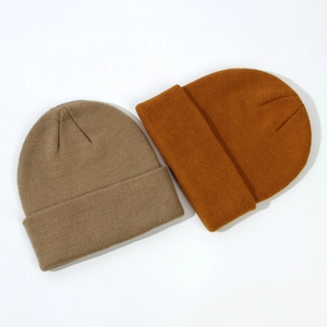 Detailed knit texture of children's beanies in khaki and mustard yellow ribbed design