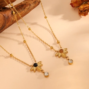 Gold bee pendant necklace with opal wings and crystal drops on a beaded chain