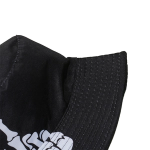 Macro shot of black canvas bucket hat with skull print and reinforced stitched brim details