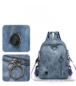 Detail of blue soft leather backpack featuring denim texture and geometric woven straps