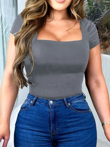 Detail of gray square neck short sleeve t-shirt paired with blue denim jeans in outdoor sun