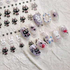 Detail showing cute black cat and white rabbit nail stickers with floral patterns