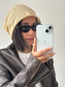 Close-up of beige linen knitted beanie featuring breathable texture and casual slouchy fit