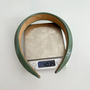 Lightweight sponge headband in sage green faux leather showing its 40g net weight