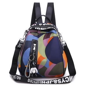 Mini nylon backpack with colorful geometric patterns and a cute bear charm pendant