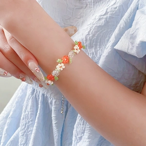 Close-up of handmade bead-woven flower bracelet with adjustable clasp on model wrist