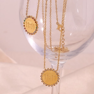 Macro detail of 18K gold plated sunflower necklace with 11:11 engraving and colorful zircons