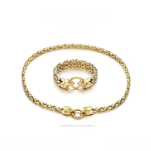 Macro view of gold stainless steel Byzantine chain skull jewelry set for men