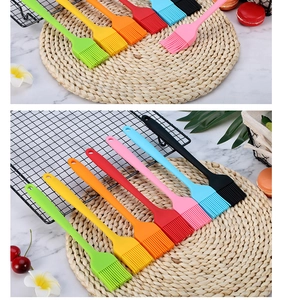 Set of eight colorful silicone basting brushes on a marble tabletop for home baking