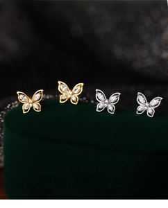 Macro detail of S999 sterling silver butterfly stud earrings with zircon stones