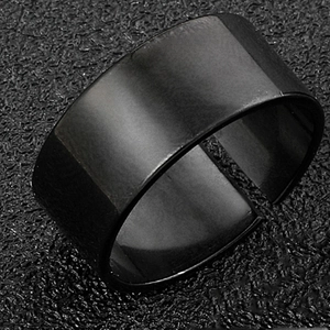 Matte black titanium steel wide open ring with a brushed texture on a dark background