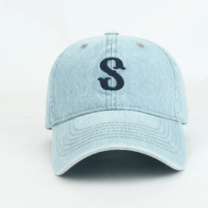 Light blue washed denim baseball cap with navy blue embroidered S letter on white background
