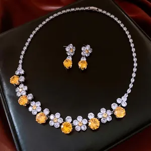 Vintage jewelry set with zircon flower necklace and earrings on elegant black leather display