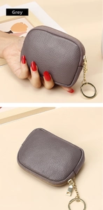 Detail of grey genuine leather coin purse with lychee texture and gold keychain ring