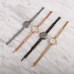 Detail of luxury mermaid bracelet watches in silver, rose gold, black, and gold colors